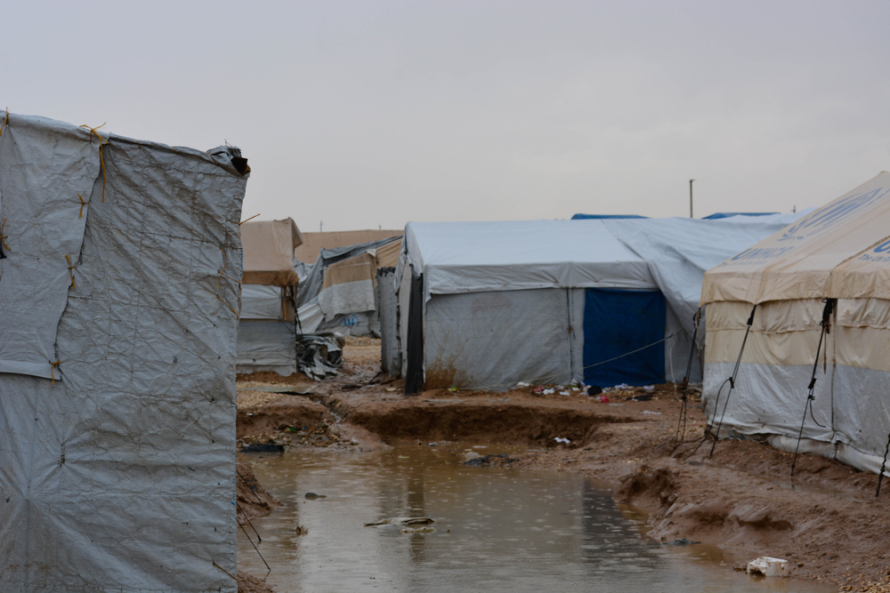 A small pond of muddy, stagnant water between two tents after heavy rains, Al-Hol camp, northeast Syria, 13/12/2023