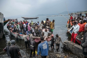 Pessoas chegam de barco ao porto de Kituku, no Lago Kivu, depois de fugirem dos combates em curso nas províncias do Kivu do Norte e do Kivu do Sul. Goma, província do Kivu do Norte, República Democrática do Congo, janeiro de 2025.