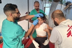 Enfermeiro da MSF trata um rapaz na unidade de queimados na Faixa de Gaza