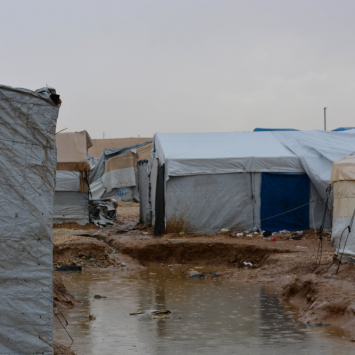 A small pond of muddy, stagnant water between two tents after heavy rains, Al-Hol camp, northeast Syria, 13/12/2023