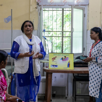 Meena Kumari e Shalini Barla, conselheiras da equipa de apoio aos pacientes, conduzem uma sessão de grupo com cuidadores de pessoas com VIH em fase avançada no hospital Guru Gobind Singh, em Patna, Bihar, Índia.